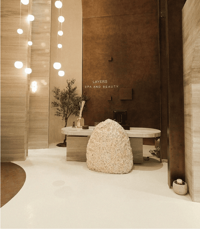 Layers wellness interior with candles and branded towels