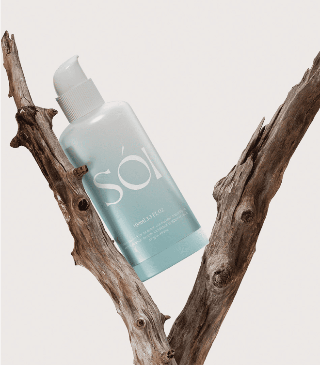 Soi skincare bottle displayed between tree branches
