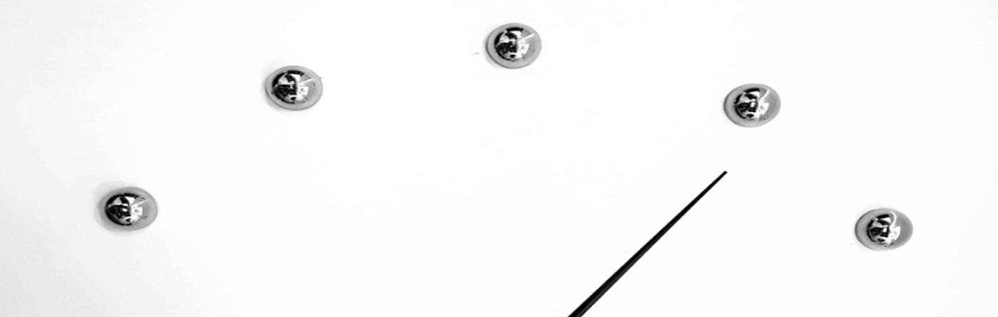 Minimalist clock face with chrome markers and a black hand